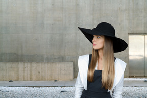 A woman with long hair wearing a black hat