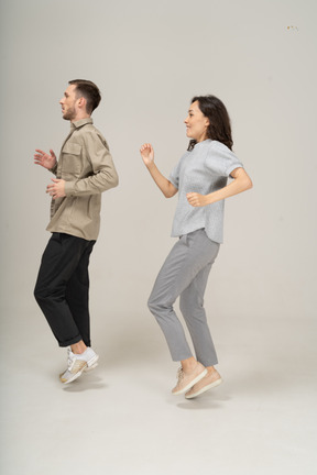 Side view of active man and woman running