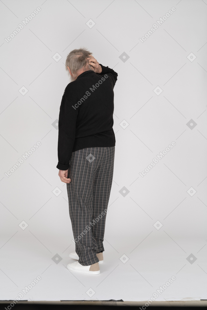 Back view of a senior man scratching his head