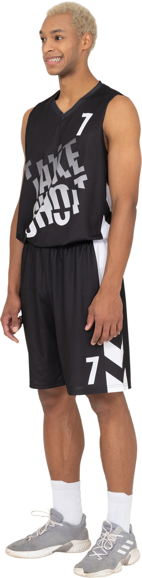 Three-quarter view of a confused young male basketball player standing still