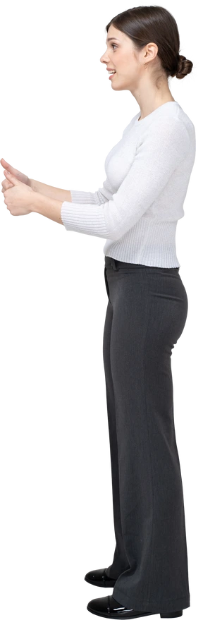 Side view of a young woman showing thumbs up