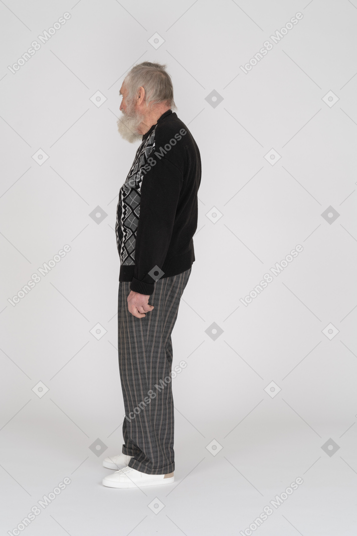 Vista lateral do homem idoso em roupas escuras