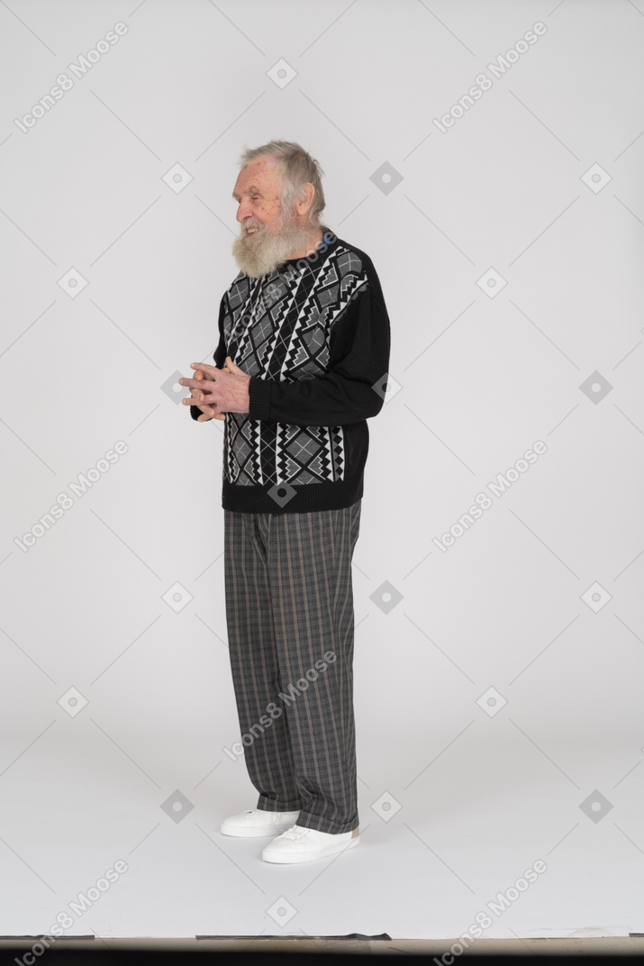 Old man smiling with hands folded