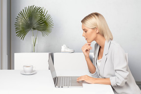 A woman sitting at a table with a laptop