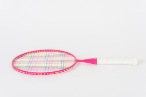 Pink tennis racket on a white background