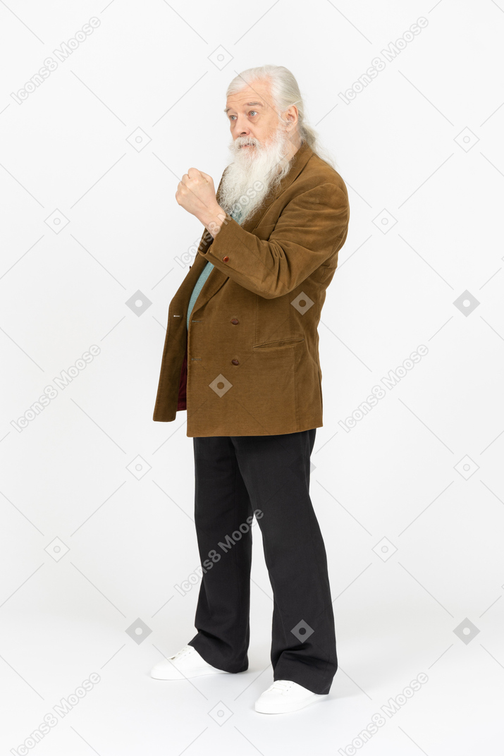 Old man shaking his fist and looking annoyed