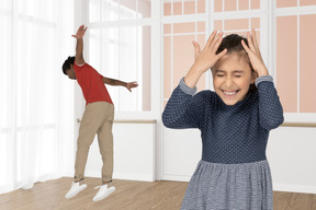 Boy and girl fooling around in room
