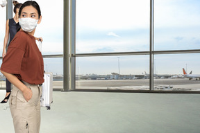 Two women standing in an airport