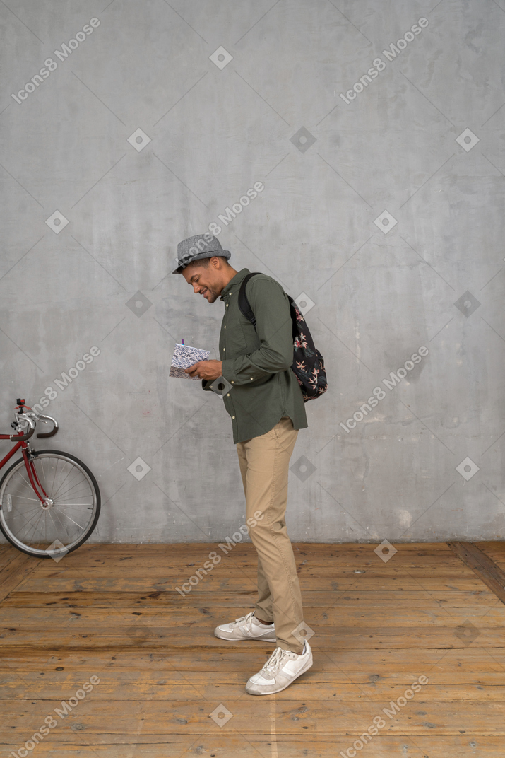 Tourist taking notes in notebook