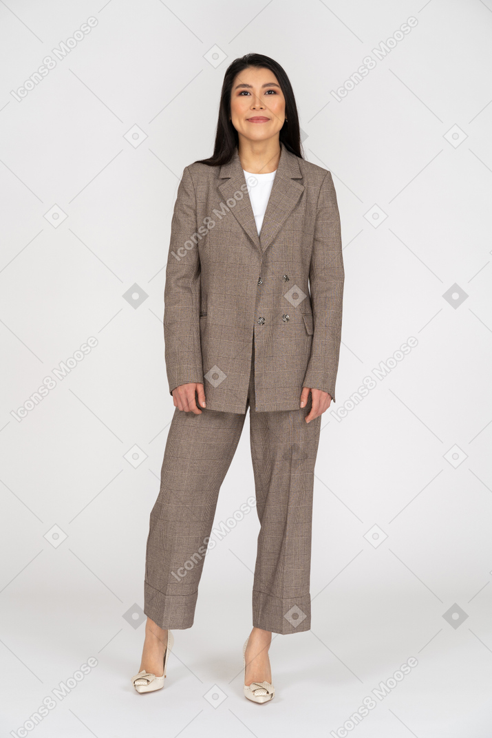 Front view of a pleased smiling young lady in brown business suit
