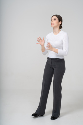 Front view of a young woman in suit looking up