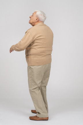 Rear view of an old man looking up