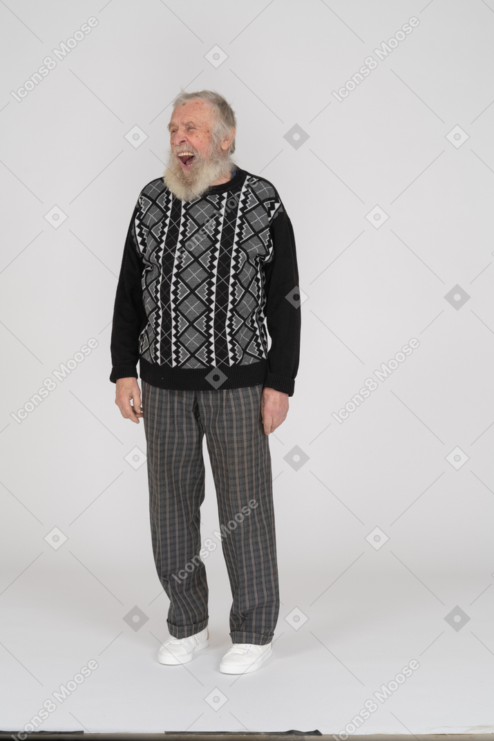 Old man standing and grimacing