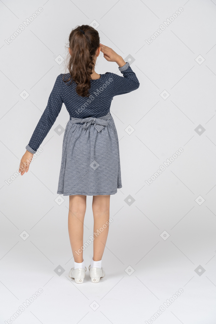 Back view of a girl saluting