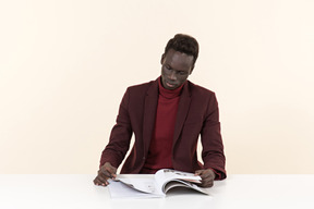 Élégant homme noir assis à la table dans le bureau