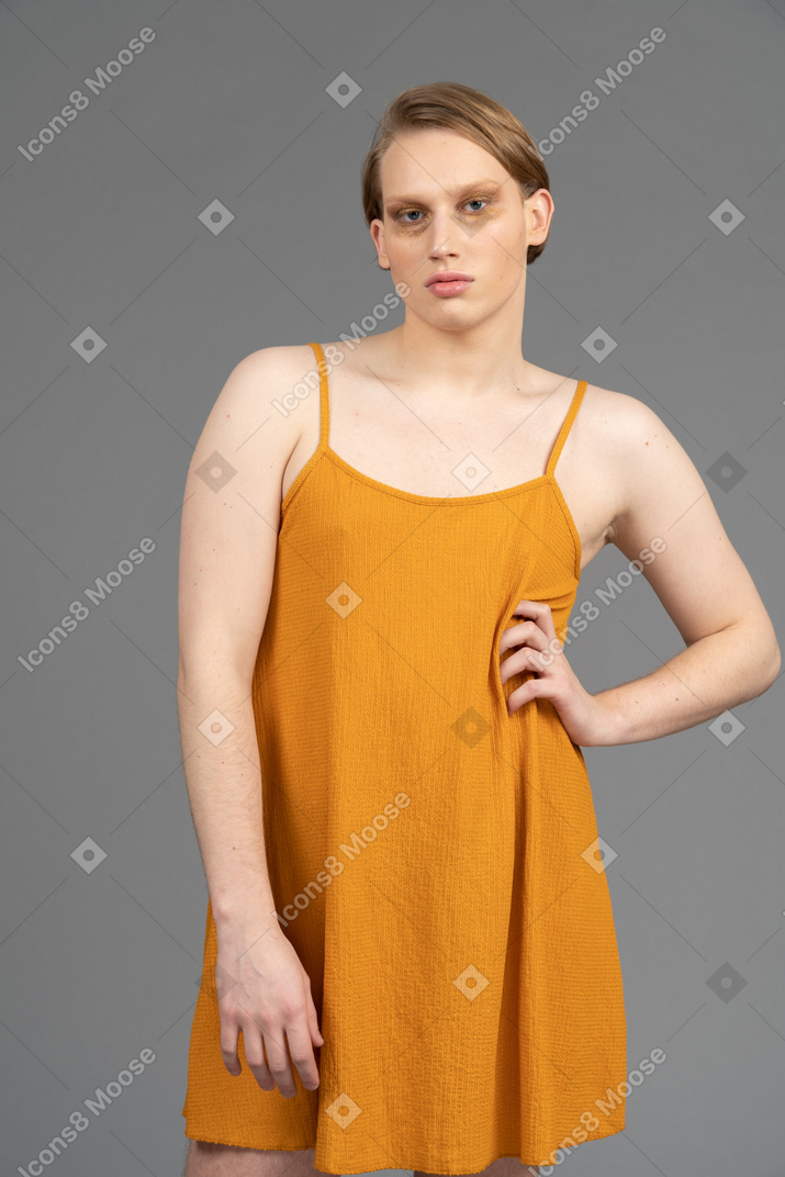 Young non-binary person posing with hand on waist