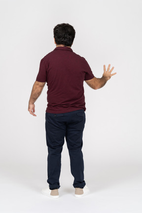 Back view of man showing four fingers
