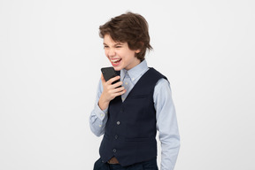 Angry schoolboy using his smartphone