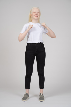 Young woman smiling with her fists up