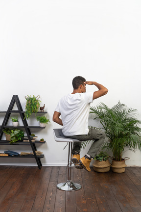 Good looking young man sitting on a chair