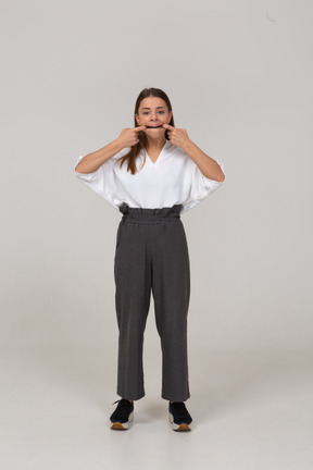 Front view of a grimacing young lady in office clothing