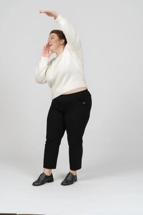 Side view of a plump woman in casual clothes with raised arm