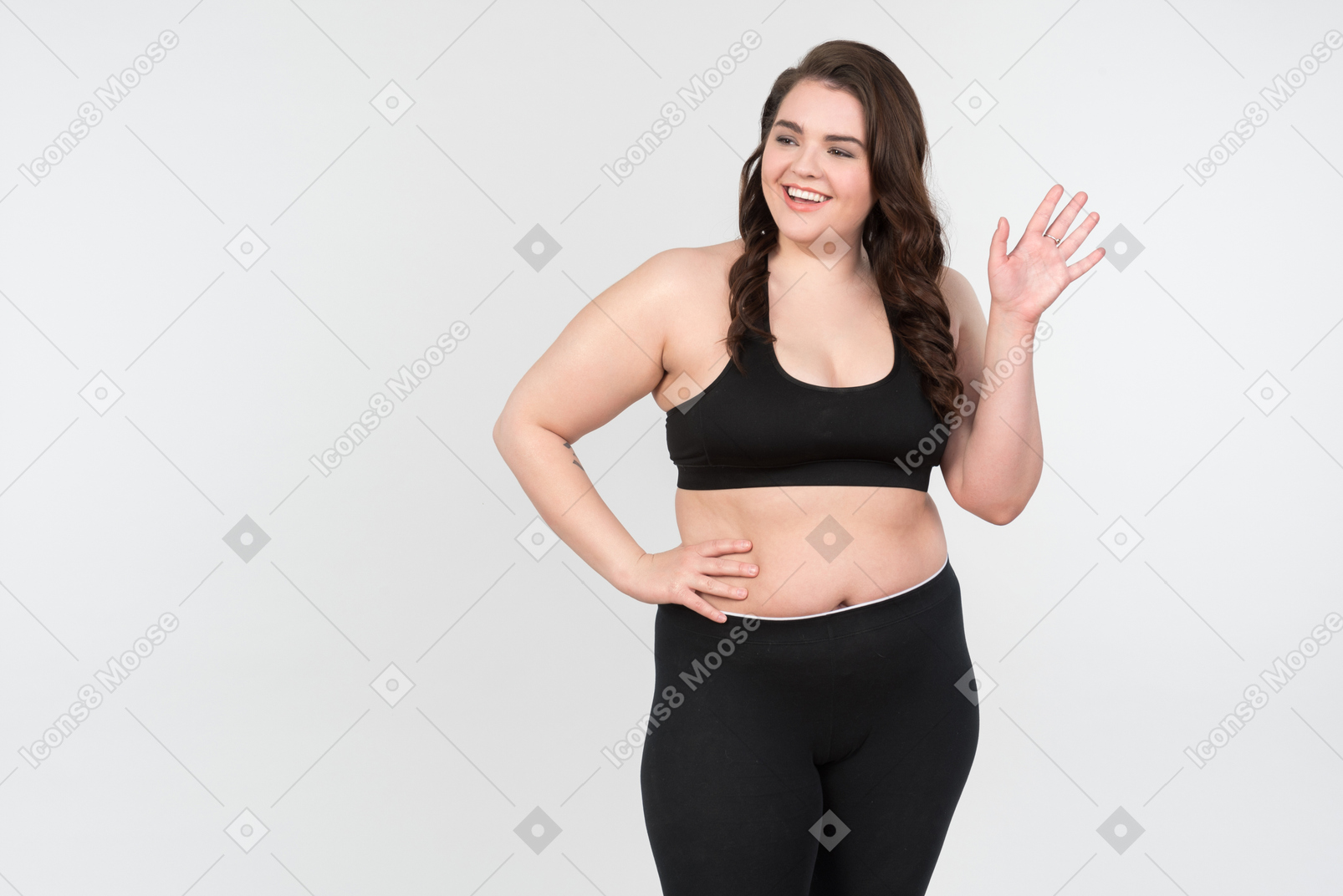 Smiling young plus-size model waving