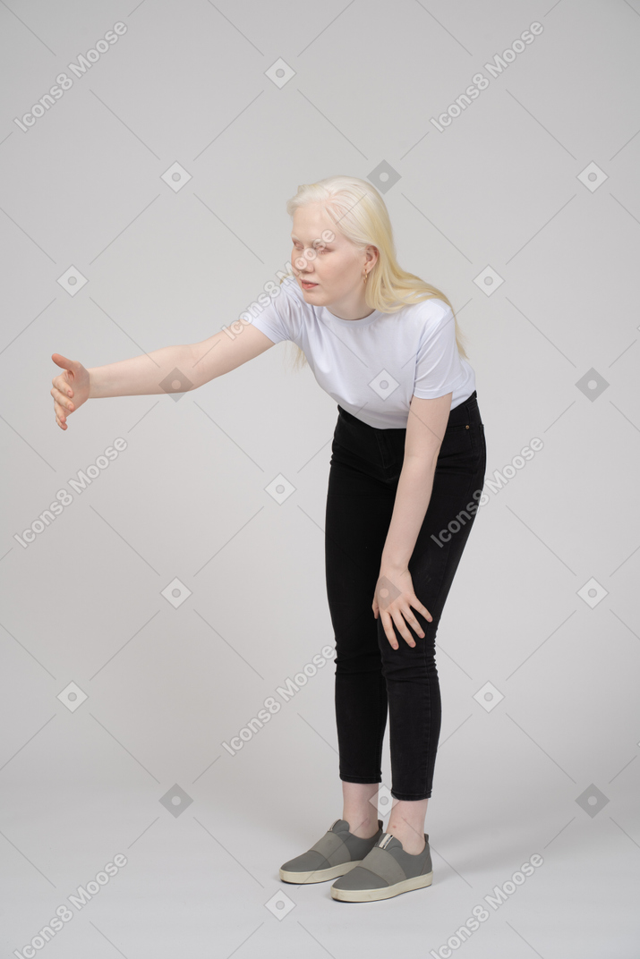 Young woman reaching her arm out