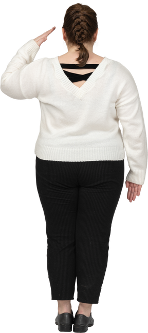 Side view of a plump woman in casual clothes saluting