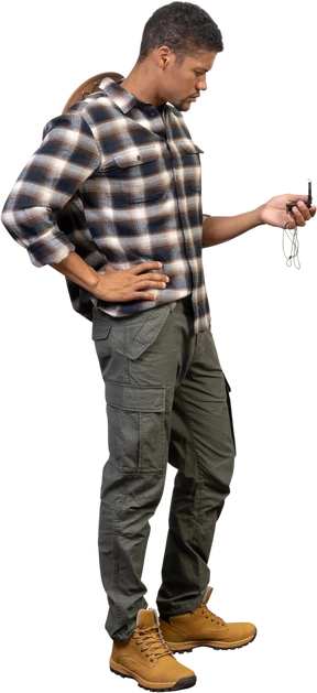 Side view of a tourist examining a compass
