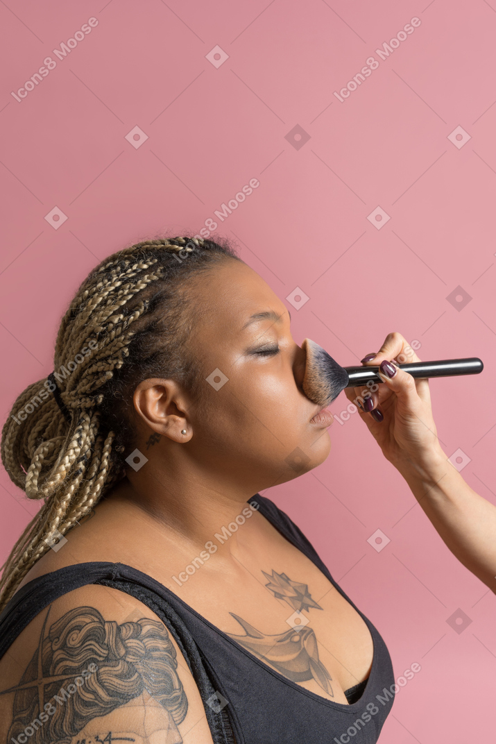 Plus size african woman getting make up
