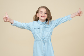 Cute little girl showing thumbs up