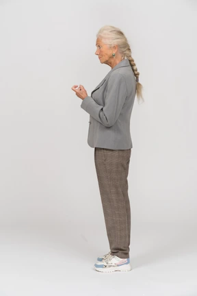 Side view of an old lady in suit asking to come closer