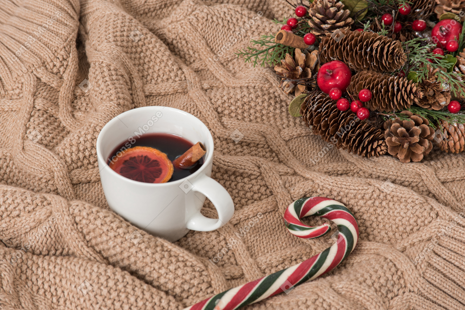Covering in blanket with cup of mulled wine
