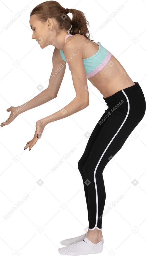 Side view of a teen girl in sportswear outspreading hands and bending down