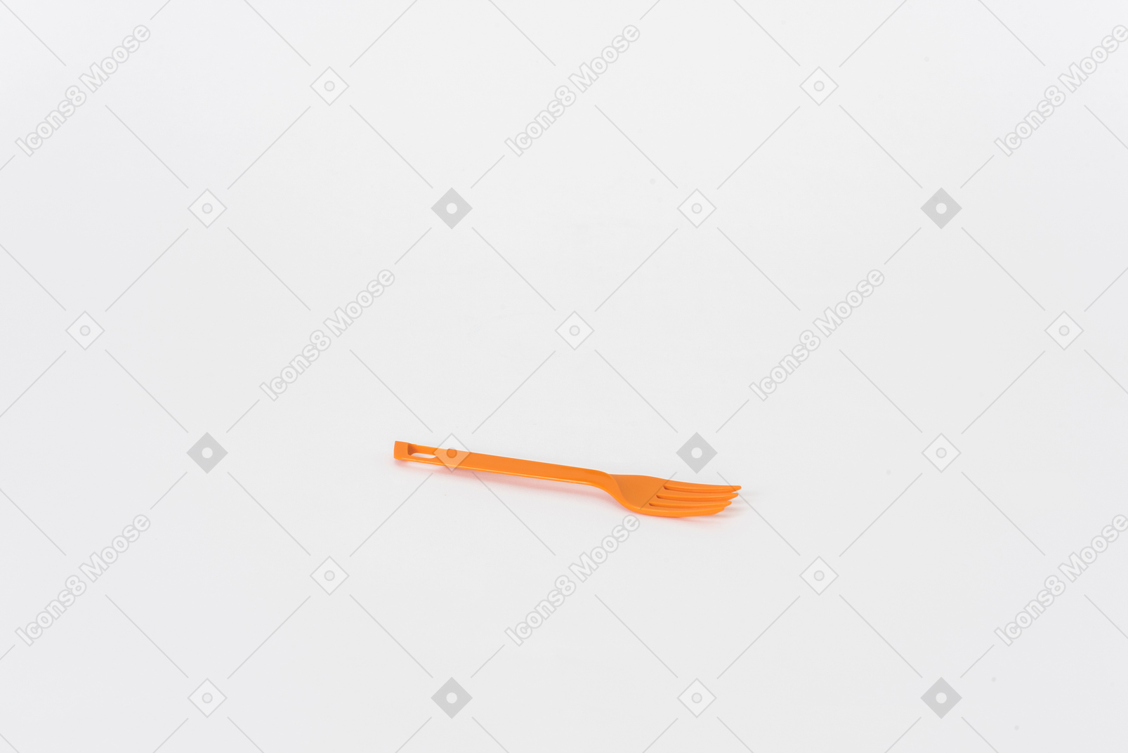 Plastic orange fork on a white background