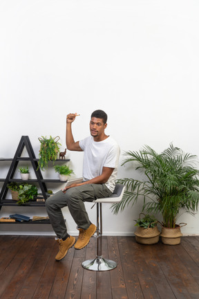 Good looking young man sitting on a chair