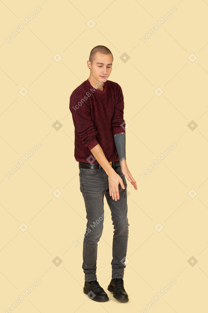 Трехчетвертный вид танцующего молодого человека, одетого в красный пуловер