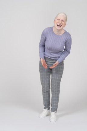 Young woman laughing and bending down
