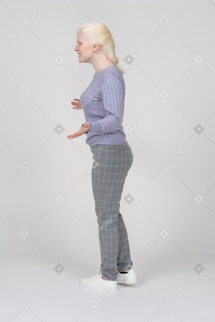 Side view of young woman spreading arms