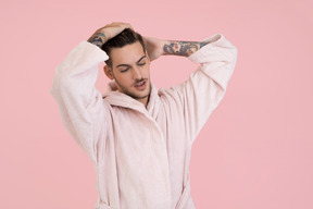 Attractive young man adjusting his hair