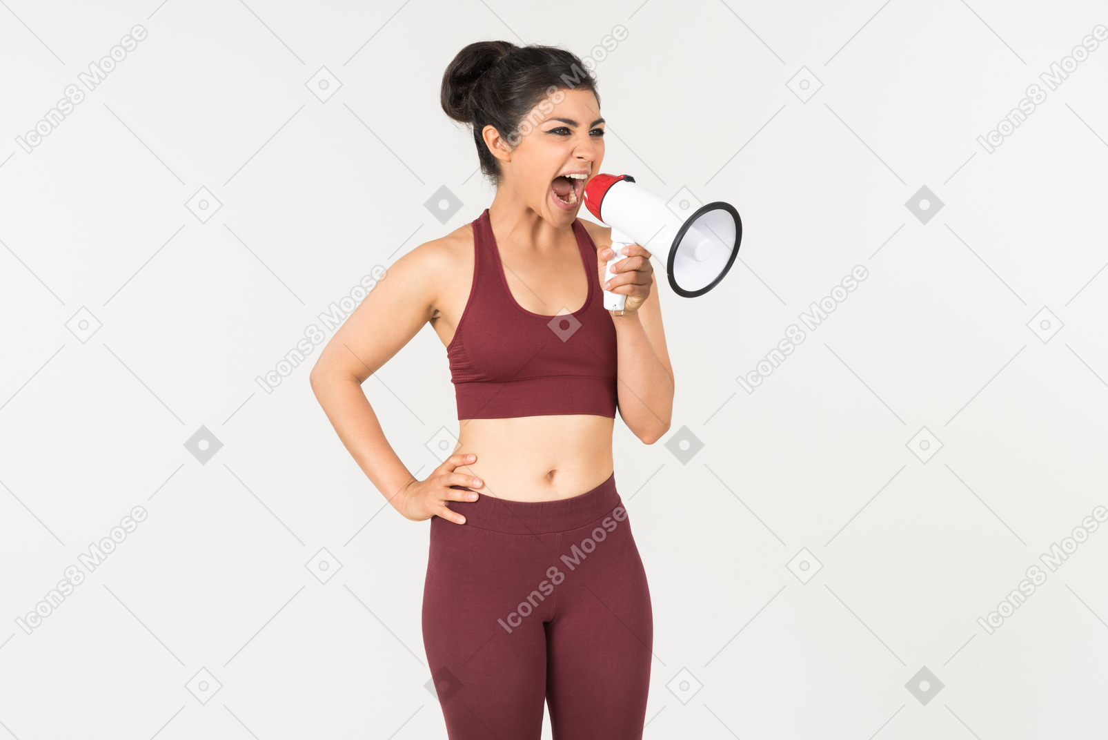 Angry looking young indian woman screaming using megaphone