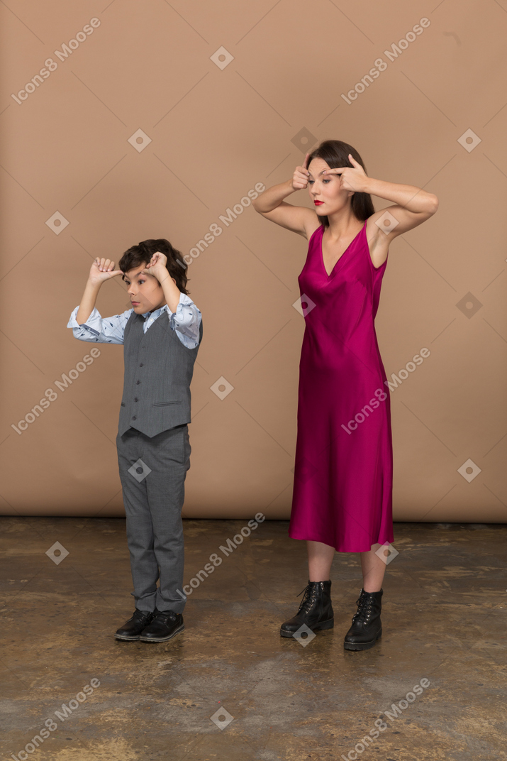 Side view of a boy and woman widening their eyes