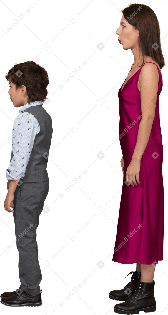 Boy and woman in red dress standing in profile