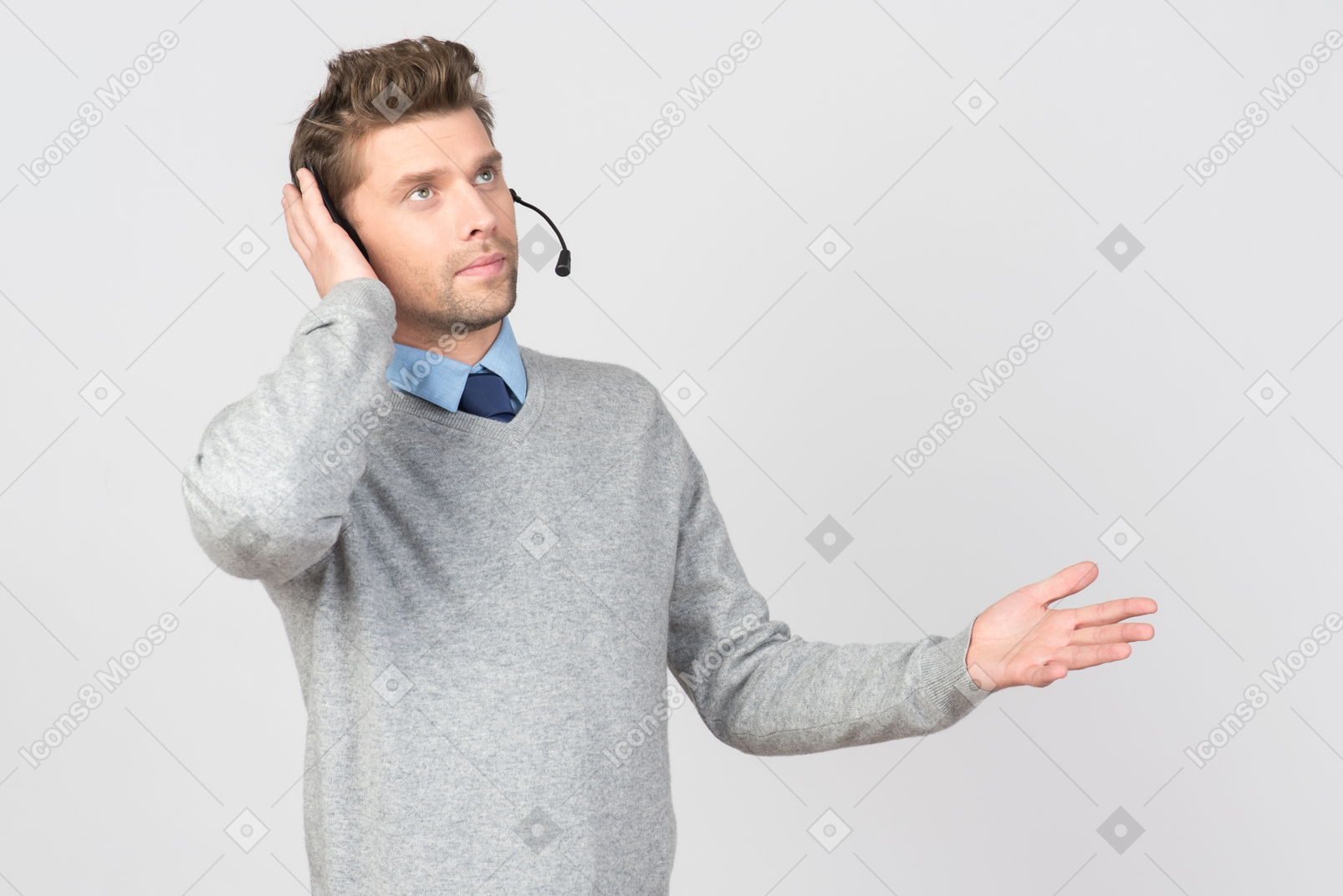 Call center agent touching headset and looking up