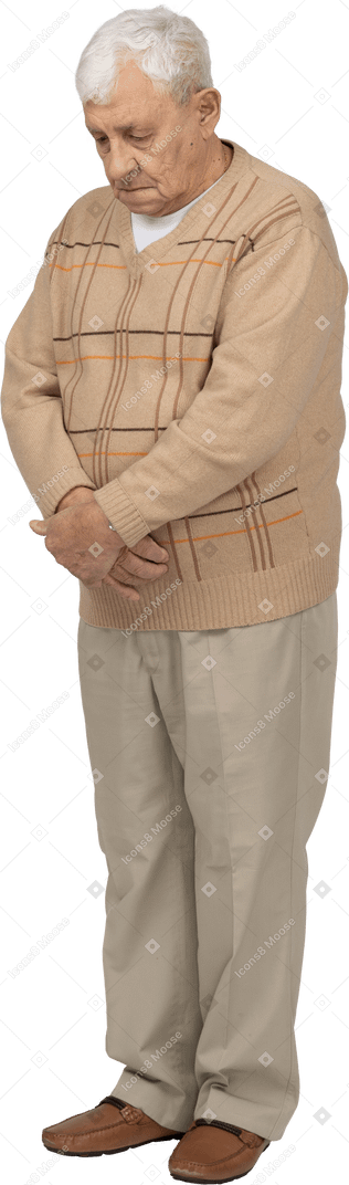 Front view of an old man in casual clothes looking down