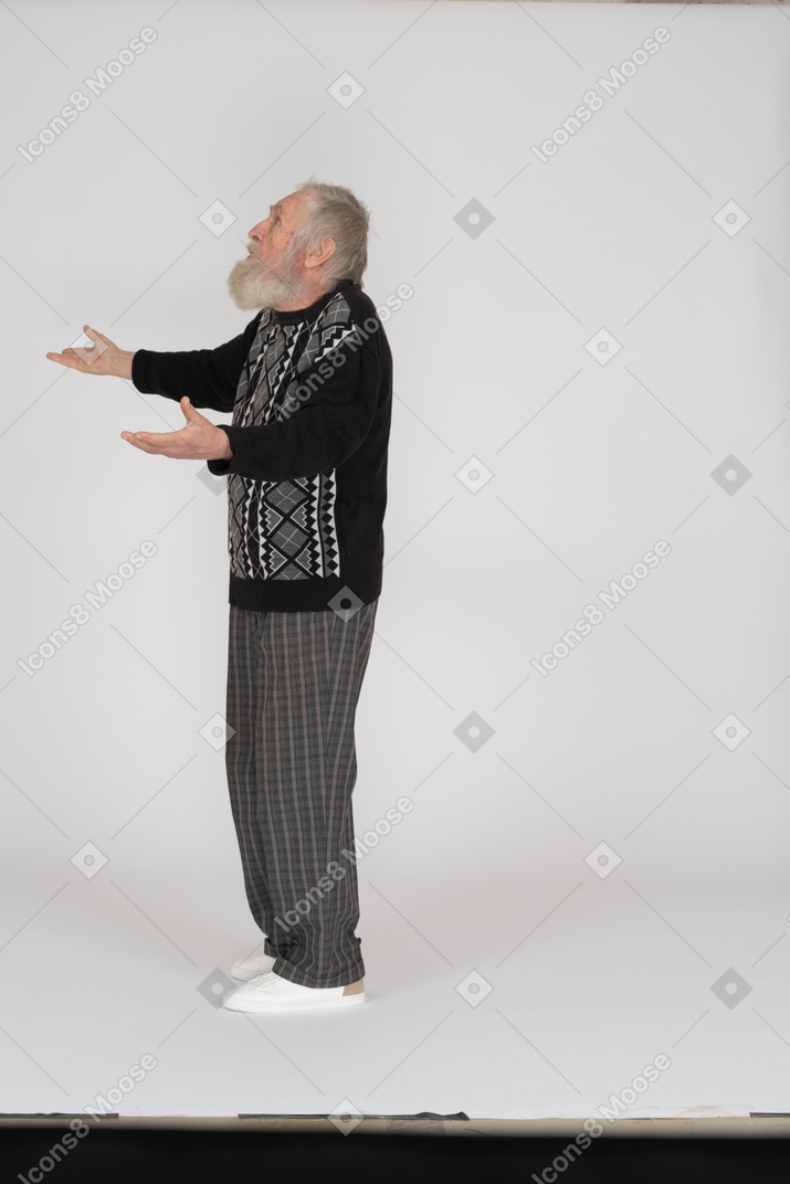 Side view of old man spreading arms