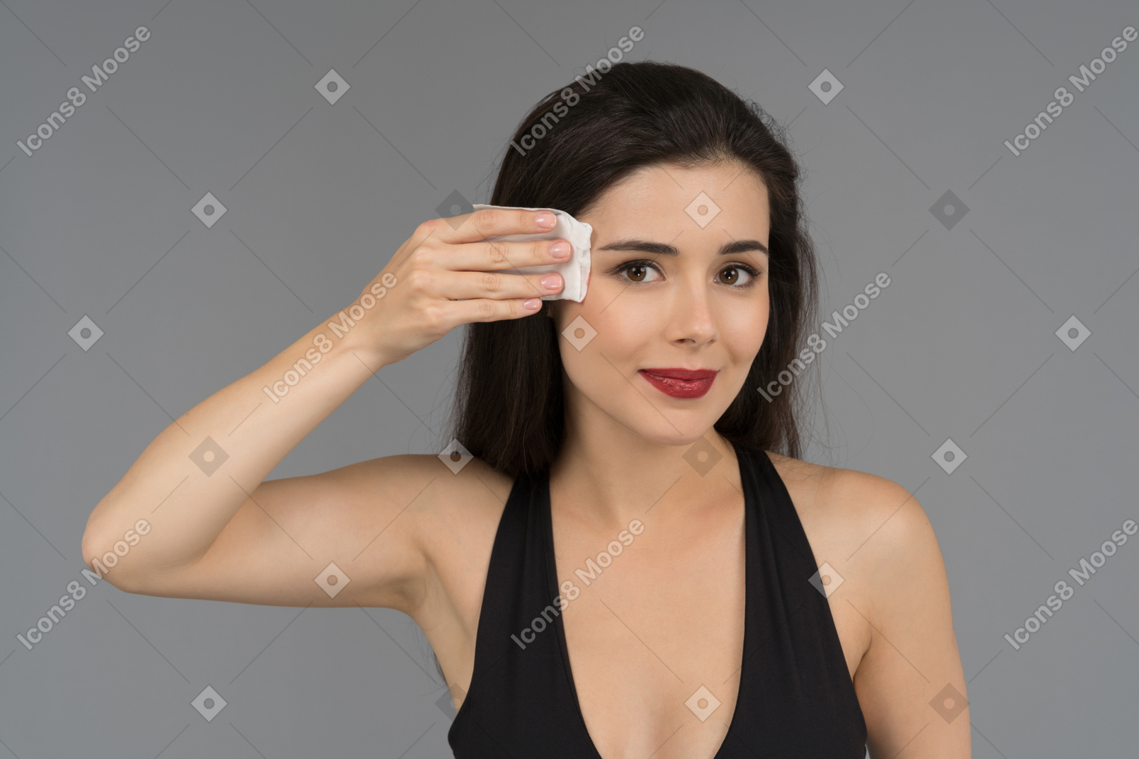 A cheerful woman wiping face