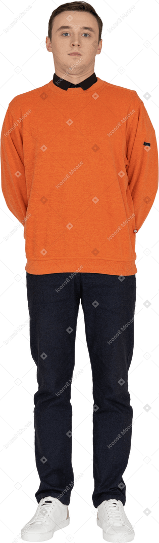 Young man in orange sweatshirt standing