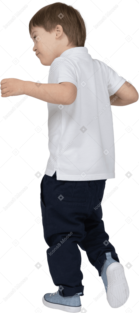 Three-quarter back view of a boy stepping forward with hands raised lightly